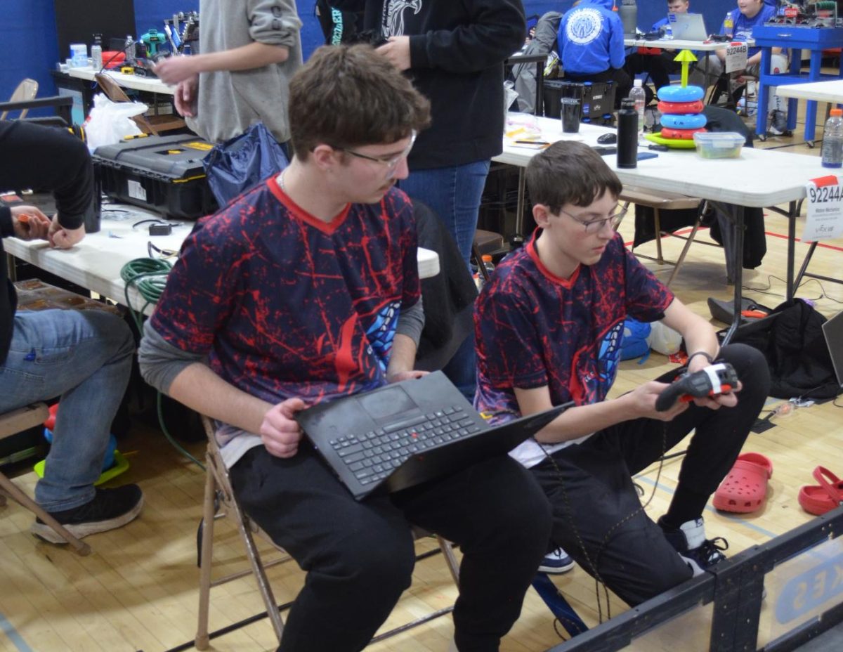 Seniors Brecken Koepke and Ty Youldan preparing to compete in the first home Robotics tournament at Albert Lea High School held on Feb 15.